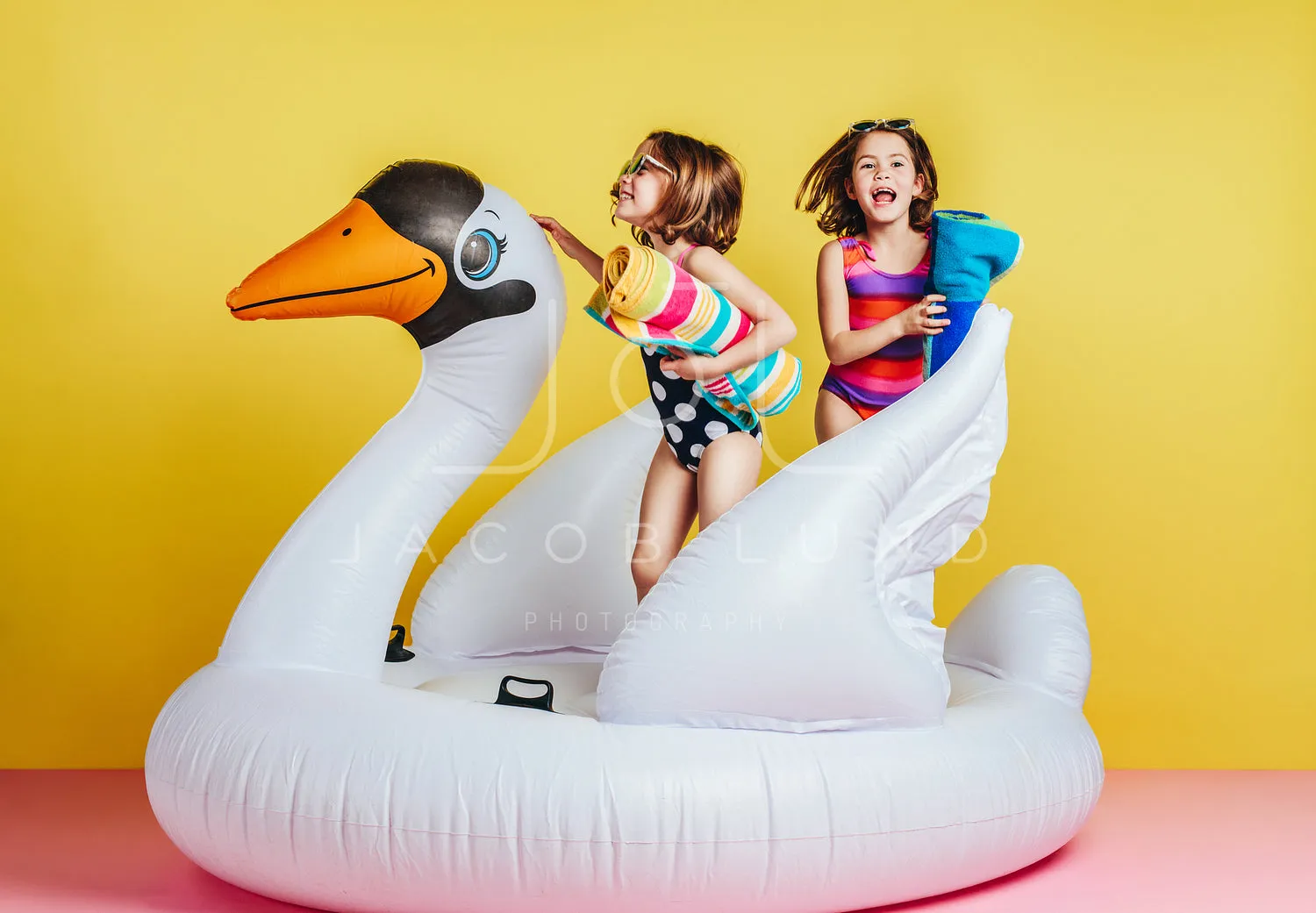 Cute young girls playing on inflatable mattress